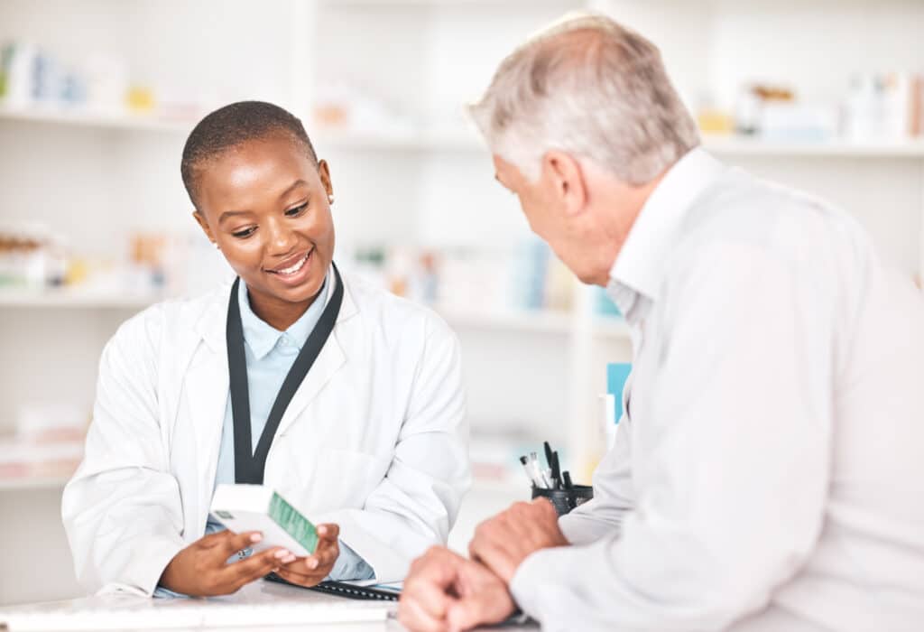 Pharmacist assisting customer with medication advice.