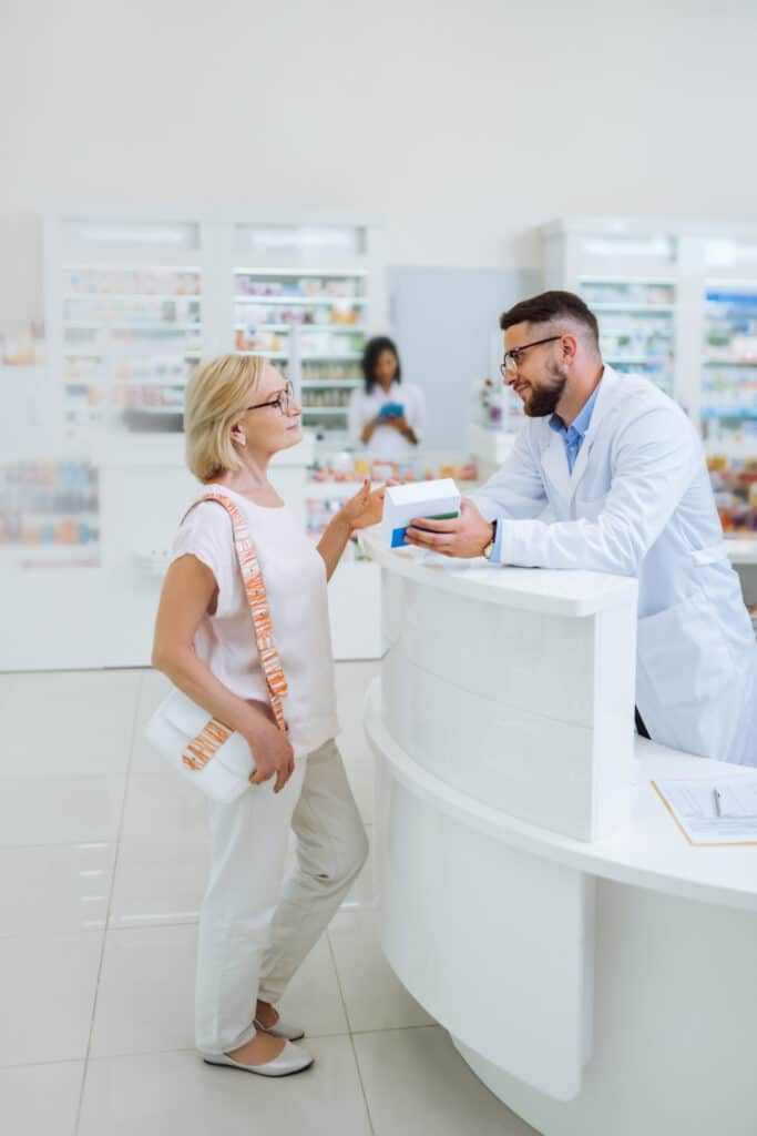 Pharmacist assisting customer at pharmacy counter