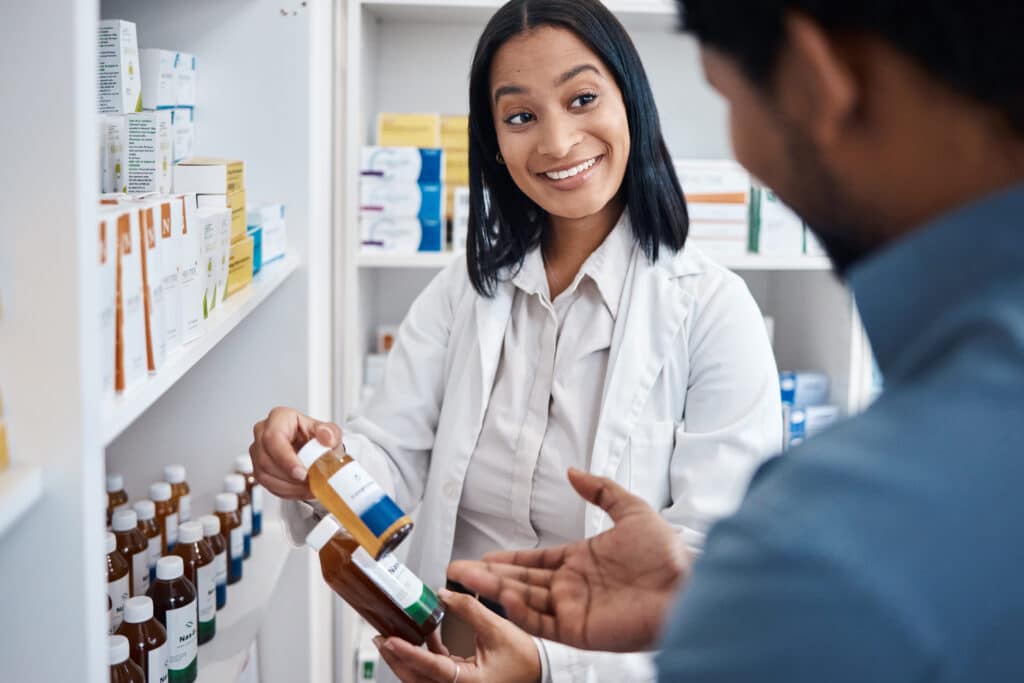 Pharmacist assisting customer with medication.
